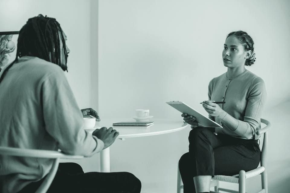 A consultant interviewing a stakeholder during a diagnostic